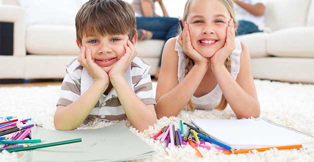 two children enjoy soft carpet while coloring on the floor